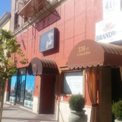 custom awnings on a red commercial building - custom commercial awnings - custom business awnings - commercial awning price - custom awning near me