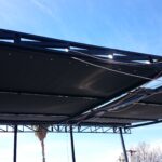 a balcony with black retractable awning - custom awnings - custom awnings near me - custom awnings for decks - custom awnings for business - custom door awnings near me - spear awnings - aluminum awnings - dome awnings