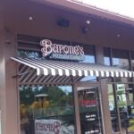 Barone's Pizzeria Express with stripe awning on its entrance - custom awnings - custom awnings near me - custom awnings for decks - custom awnings for business - custom door awnings near me - spear awnings - aluminum awnings - dome awnings