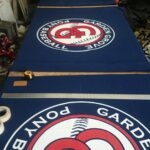 "Garden Grove Pony Baseball" sign laid on a table - custom awnings - custom awnings near me - custom awnings for decks - custom awnings for business - custom door awnings near me - spear awnings - aluminum awnings - dome awnings