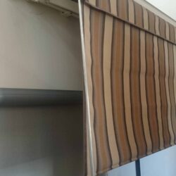 stripe retractable awning installed on a wall - custom awnings - custom awnings near me - custom awnings for decks - custom awnings for business - custom door awnings near me - spear awnings - aluminum awnings - dome awnings