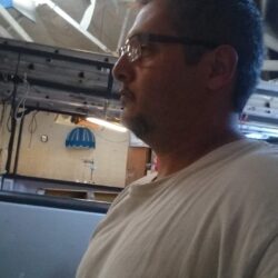 a man wearing a white shirt and glasses - custom awnings - custom awnings near me - custom awnings for decks - custom awnings for business - custom door awnings near me - spear awnings - aluminum awnings - dome awnings