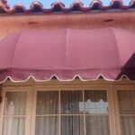 orange house with red dome awnings for windows - custom awnings - custom awnings near me - custom awnings for decks - custom awnings for business - custom door awnings near me - spear awnings - aluminum awnings - dome awnings