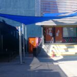 outdoor space with a blue sail shade - custom awnings - custom awnings near me - custom awnings for decks - custom awnings for business - custom door awnings near me - spear awnings - aluminum awnings - dome awnings