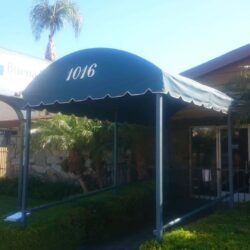 store with a garden and an entrance canopy - custom awnings - custom awnings near me - custom awnings for decks - custom awnings for business - custom door awnings near me - spear awnings - aluminum awnings - dome awnings