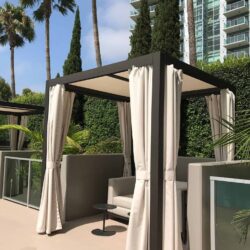 patio with a sofa and white cabana - custom awnings - custom awnings near me - custom awnings for decks - custom awnings for business - custom door awnings near me - spear awnings - aluminum awnings - dome awnings