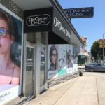 Optometric Options with black storefront awning - custom awnings - custom awnings near me - custom awnings for decks - custom awnings for business - custom door awnings near me - spear awnings - aluminum awnings - dome awnings