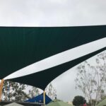 outdoor space with a green sail shade - custom awnings - custom awnings near me - custom awnings for decks - custom awnings for business - custom door awnings near me - spear awnings - aluminum awnings - dome awnings