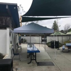 white cabanas with long table and chairs - concave awnings - aluminum awnings - carports - store front awnings - patio shades