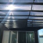 balcony with black slide on wire retractable awning - custom awnings - custom awnings near me - custom awnings for decks - custom awnings for business - custom door awnings near me - spear awnings - aluminum awnings - dome awnings