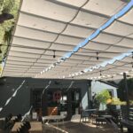 slide on wire retractable awnings for a restaurant's outdoor dining - custom awnings - custom awnings near me - custom awnings for decks - custom awnings for business - custom door awnings near me - spear awnings - aluminum awnings - dome awnings