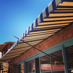 restaurant with stripe spear awnings - custom awnings - custom awnings near me - custom awnings for decks - custom awnings for business - custom door awnings near me - spear awnings - aluminum awnings - dome awnings