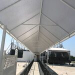 white building with a white entrance canopy - custom awnings - custom awnings near me - custom awnings for decks - custom awnings for business - custom door awnings near me - spear awnings - aluminum awnings - dome awnings