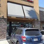 Verizon store with grey awnings for entrance and a car parked in front - custom awnings - custom awnings near me - custom awnings for decks - custom awnings for business - custom door awnings near me - spear awnings - aluminum awnings - dome awnings