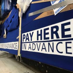 "pay here in advance" sign laid on a table - custom awnings - custom awnings near me - custom awnings for decks - custom awnings for business - custom door awnings near me - spear awnings - aluminum awnings - dome awnings