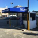 blue awnings for a car parking booth - concave awnings - aluminum awnings - carports - store front awnings - patio shades