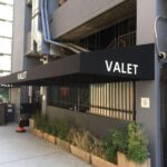 grey building with black awnings for valet - custom awnings - custom awnings near me - custom awnings for decks - custom awnings for business - custom door awnings near me - spear awnings - aluminum awnings - dome awnings