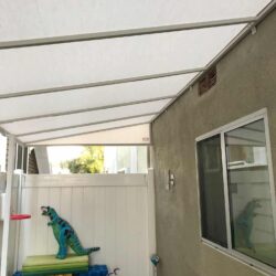 house with a white awning with toys in the background - custom awnings - custom awnings near me - custom awnings for decks - custom awnings for business - custom door awnings near me - spear awnings - aluminum awnings - dome awnings