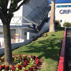 blue awnings being installed on a white building - custom awnings - custom awnings near me - custom awnings for decks - custom awnings for business - custom door awnings near me - spear awnings - aluminum awnings - dome awnings