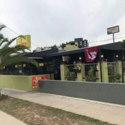 green Benny's store with black awnings - custom awnings - custom awnings near me - custom awnings for decks - custom awnings for business - custom door awnings near me - spear awnings - aluminum awnings - dome awnings