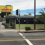 green Benny's store with black awnings - custom awnings - custom awnings near me - custom awnings for decks - custom awnings for business - custom door awnings near me - spear awnings - aluminum awnings - dome awnings
