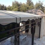 house with a cream residential awning - custom awnings - custom awnings near me - custom awnings for decks - custom awnings for business - custom door awnings near me - spear awnings - aluminum awnings - dome awnings