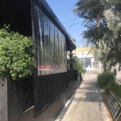restaurant with black drapes for its balcony seating - custom awnings - custom awnings near me - custom awnings for decks - custom awnings for business - custom door awnings near me - spear awnings - aluminum awnings - dome awnings