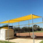 outdoor space with a yellow sail shade - custom awnings - custom awnings near me - custom awnings for decks - custom awnings for business - custom door awnings near me - spear awnings - aluminum awnings - dome awnings