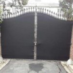 a gate with a brown privacy panel - custom awnings - custom awnings near me - custom awnings for decks - custom awnings for business - custom door awnings near me - spear awnings - aluminum awnings - dome awnings