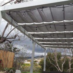 garden with aluminum awning with hanging lights - custom awnings - custom awnings near me - custom awnings for decks - custom awnings for business - custom door awnings near me - spear awnings - aluminum awnings - dome awnings