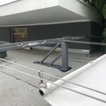 white awnings attached to a grey house - custom awnings - custom awnings near me - custom awnings for decks - custom awnings for business - custom door awnings near me - spear awnings - aluminum awnings - dome awnings