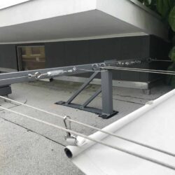 white awnings attached to a grey house - custom awnings - custom awnings near me - custom awnings for decks - custom awnings for business - custom door awnings near me - spear awnings - aluminum awnings - dome awnings