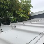 white awnings attached to a grey house - custom awnings - custom awnings near me - custom awnings for decks - custom awnings for business - custom door awnings near me - spear awnings - aluminum awnings - dome awnings