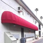 red round awning for a house with two windows and two air conditioner - custom awnings - custom awnings near me - custom awnings for decks - custom awnings for business - custom door awnings near me - spear awnings - aluminum awnings - dome awnings