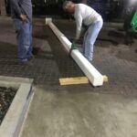 man fixing a white pole - custom awnings - custom awnings near me - custom awnings for decks - custom awnings for business - custom door awnings near me - spear awnings - aluminum awnings - dome awnings
