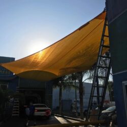 outdoor space with yellow sail shade - custom awnings - custom awnings near me - custom awnings for decks - custom awnings for business - custom door awnings near me - spear awnings - aluminum awnings - dome awnings