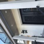 a house with a balcony and black door - custom awnings - custom awnings near me - custom awnings for decks - custom awnings for business - custom door awnings near me - spear awnings - aluminum awnings - dome awnings