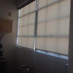 a room with two trash cans and roll up curtains - custom awnings - custom awnings near me - custom awnings for decks - custom awnings for business - custom door awnings near me - spear awnings - aluminum awnings - dome awnings