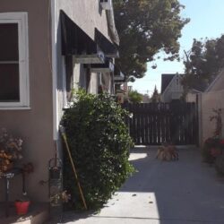 house with black awnings for windows - custom awnings - custom awnings near me - custom awnings for decks - custom awnings for business - custom door awnings near me - spear awnings - aluminum awnings - dome awnings