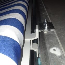stripe blue awning installed on a house - custom awnings - custom awnings near me - custom awnings for decks - custom awnings for business - custom door awnings near me - spear awnings - aluminum awnings - dome awnings