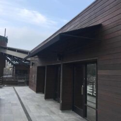 black awnings for a large wooden house - standard awnings - concave awnings - aluminum awnings - carports - store front awnings - patio shades