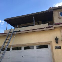 large brown awning for the balcony of a two-storey house - standard awnings - concave awnings - aluminum awnings - carports - store front awnings - patio shades