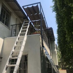 awnings for the balcony of a two-storey house with a ladder - standard awnings - concave awnings - aluminum awnings - carports - store front awnings - patio shades