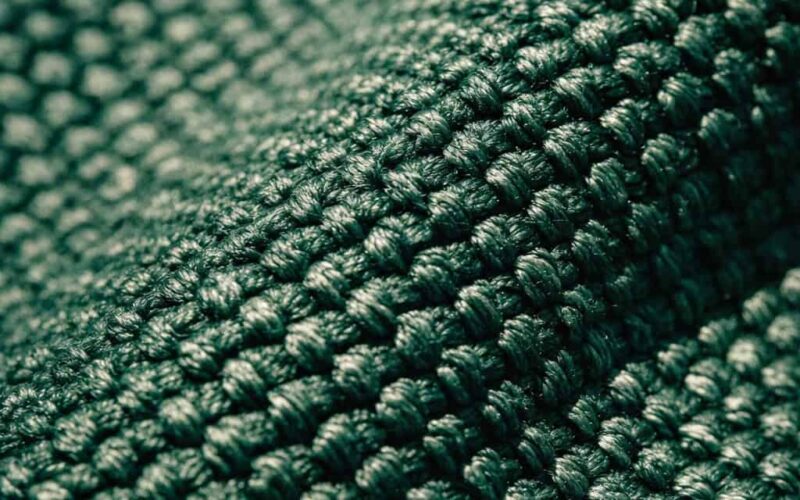 Close up of high quality sunbrella fabric texture, forest green canvas, macro photography, sunligh